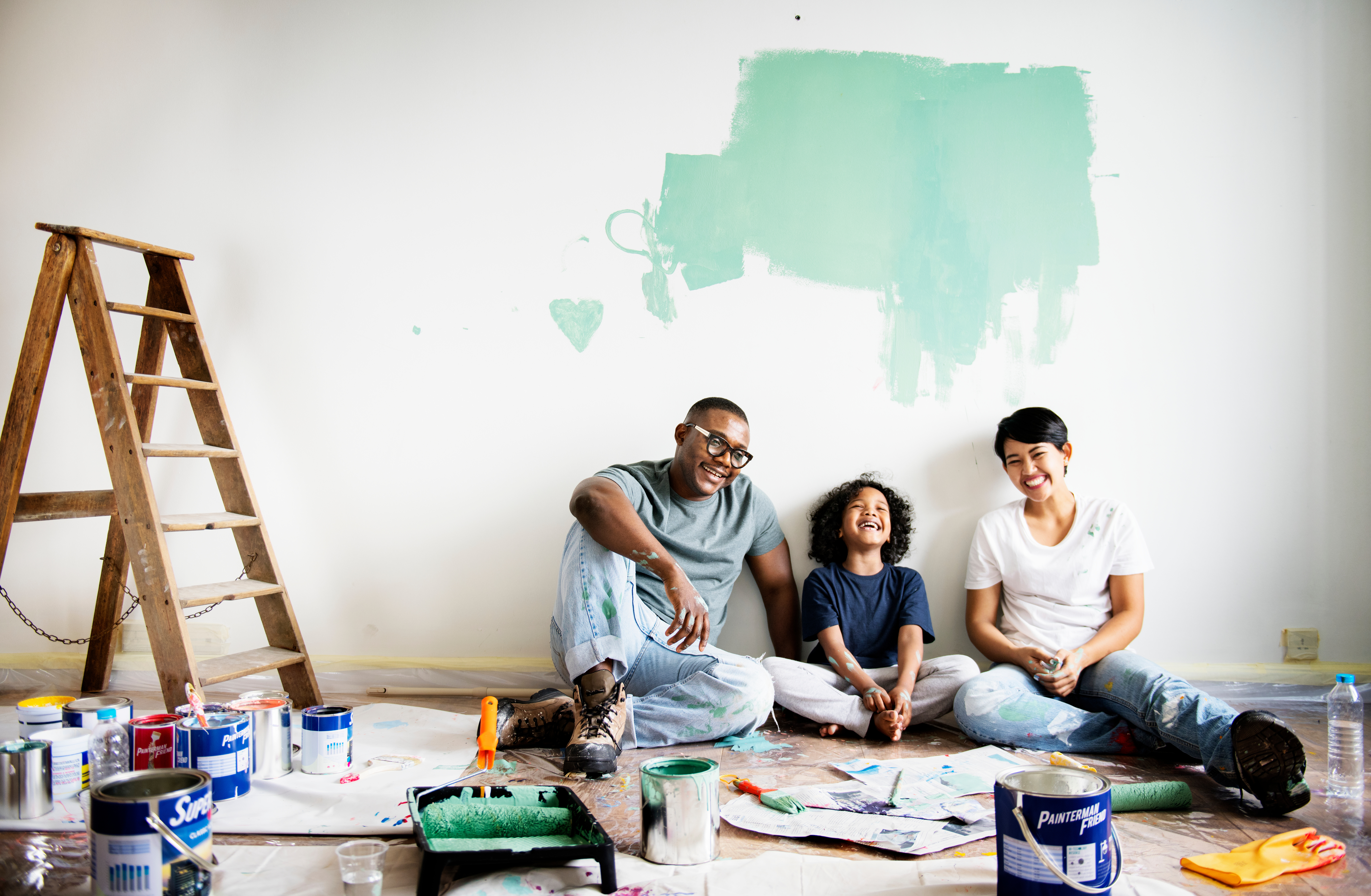 A family enjoys painting their living room after securing a home equity loan.